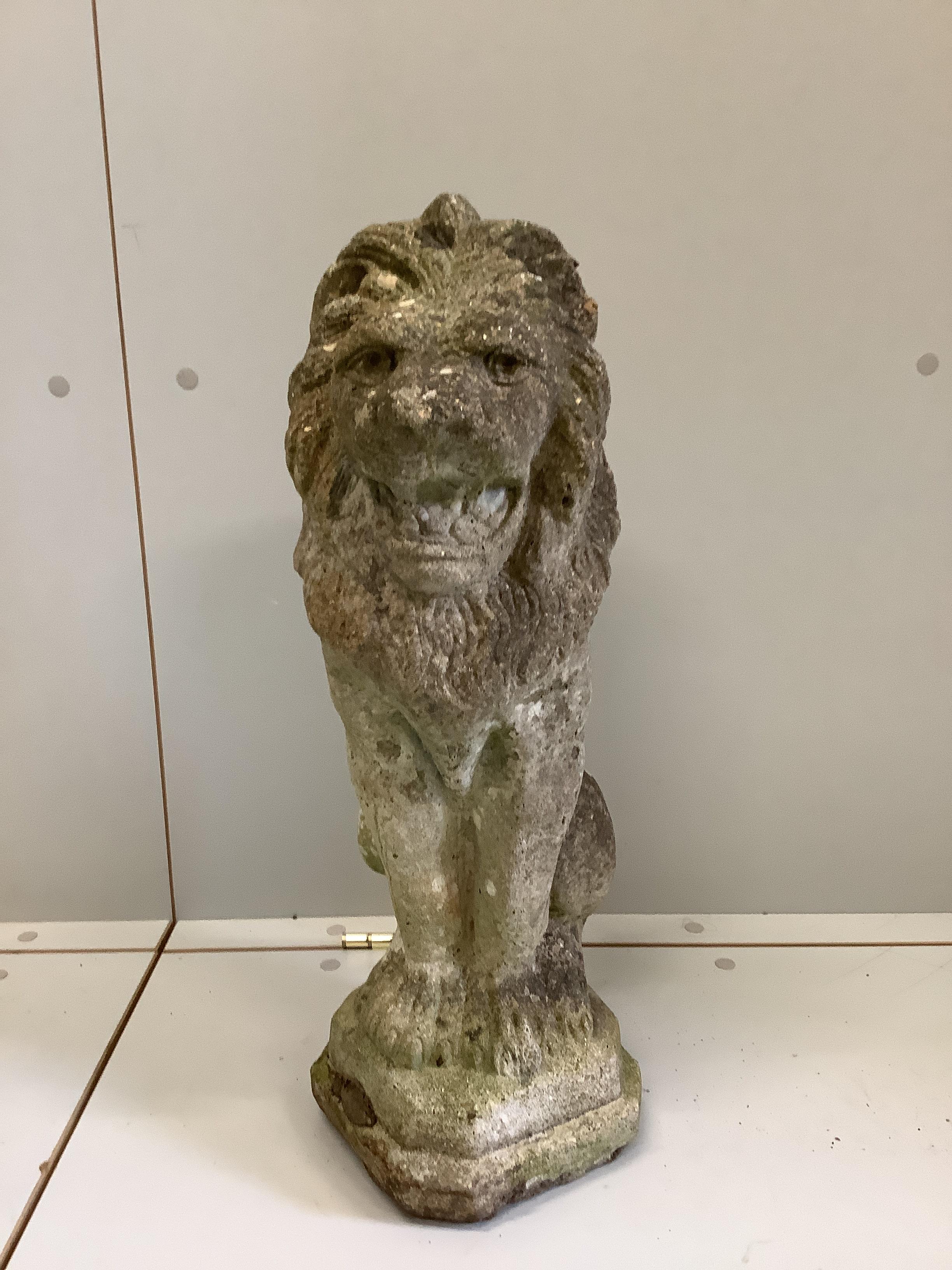 A reconstituted stone seated lion garden ornament, height 55cm